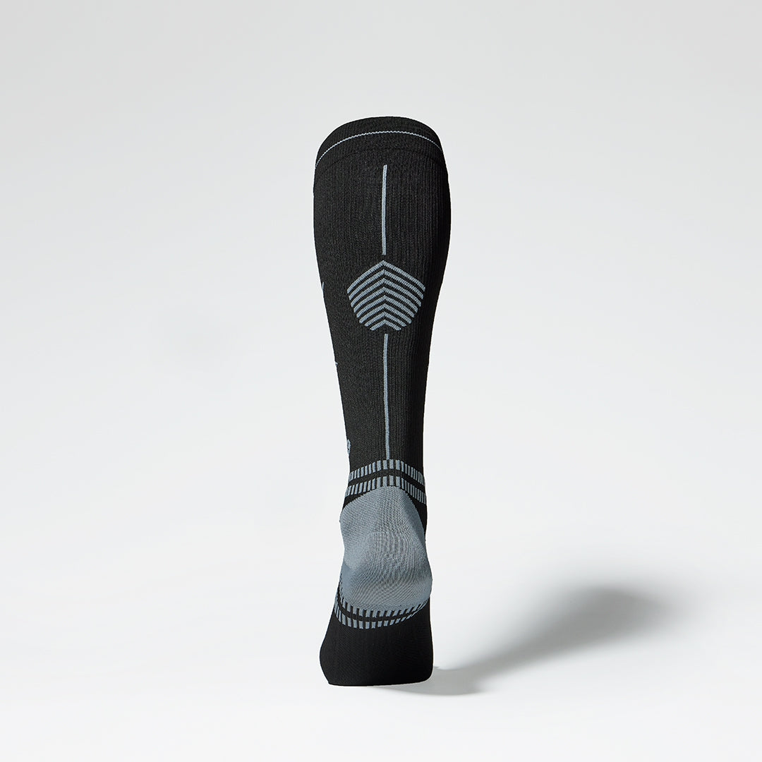 Back view of black knee high sock with grey accents.